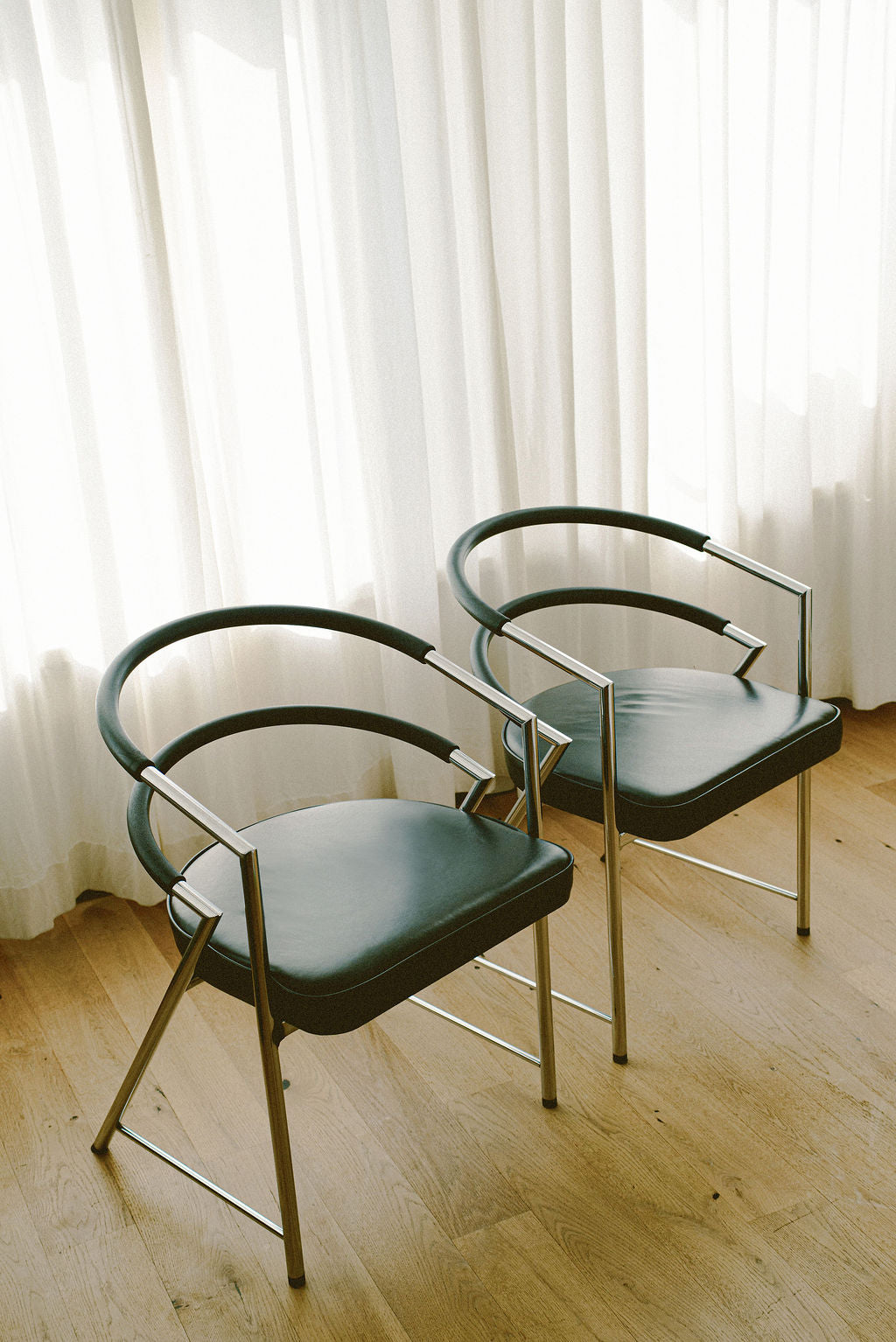 Modernist Chrome and Black Upholstered Armchairs
