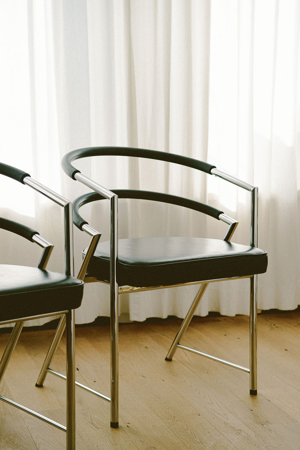 Modernist Chrome and Black Upholstered Armchairs